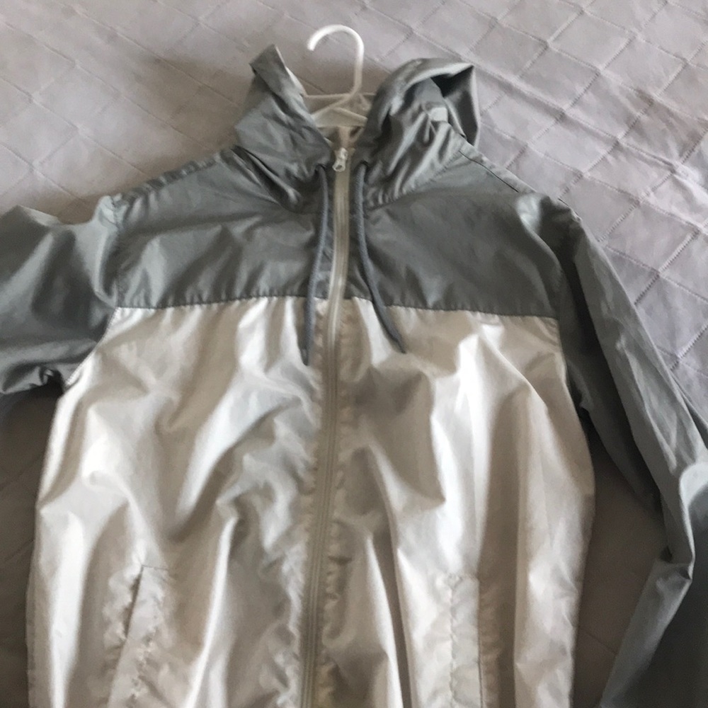 A gray and white wind breaker brand new